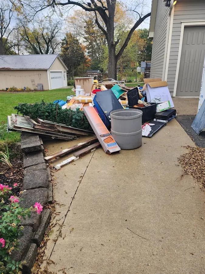 Dumpster being loaded with debris for 30 Yard Dumpster Rental in Hudson Bend
